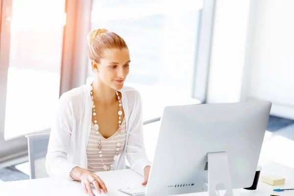 Attractive office worker sitting at desk — Stock Photo, Image