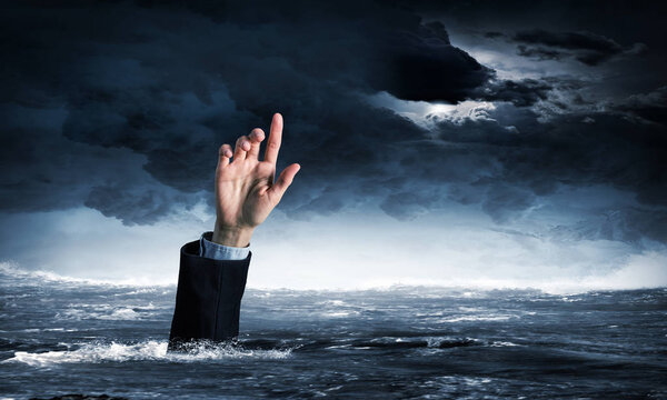 Hand of person drowning in water