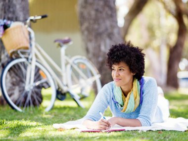 Güzel genç kadın açık havada günlüğüne yazma