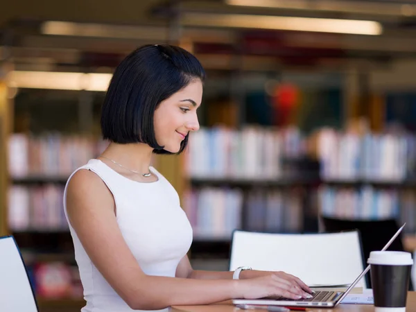 Happy female student at the library — Stock Photo, Image