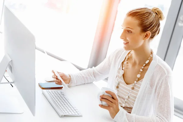 Attractive office worker sitting at desk — Stock Photo, Image