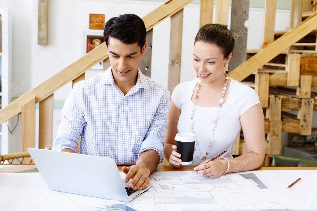 Two young architects in office