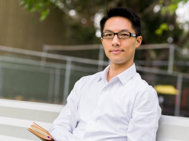 Not Defteri ile bankta oturmuş çekici düşünceli işadamı