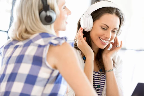 Young woman with headphones indoors — Stock Photo, Image