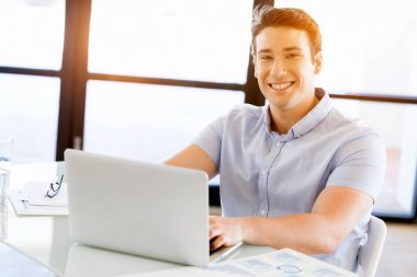 Bilgisayarda çalışan yakışıklı işadamı