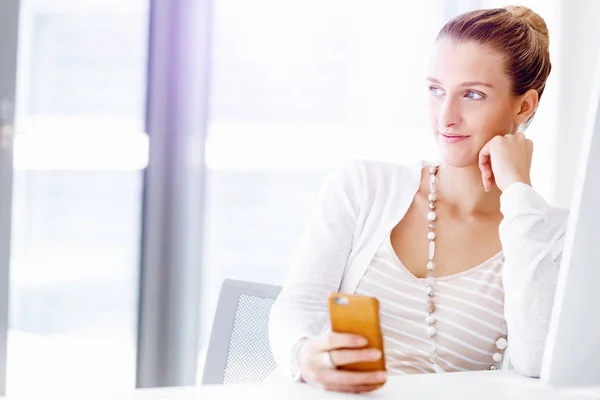 Attractive office worker sitting at desk — Stock Photo, Image