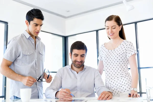 Groep van gelukkige jonge zakenmensen in een vergadering — Stockfoto