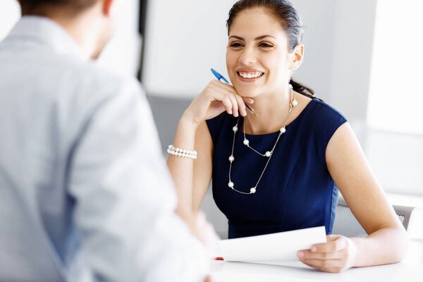 Attractive office worker sitting at desk