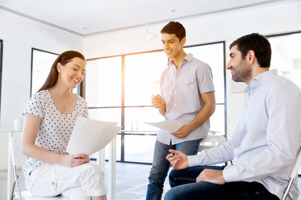 Image of business partners discussing documents and ideas