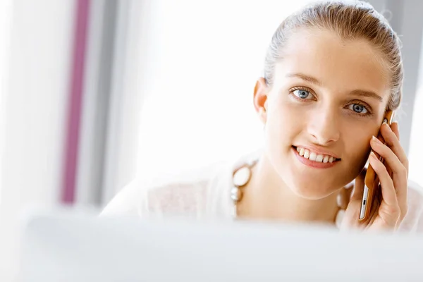 Attractive office worker sitting at desk — Stock Photo, Image