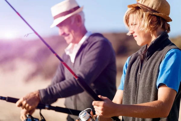 Senior man fishing with his grandson — Stock Photo, Image