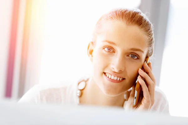 Attractive office worker sitting at desk — Stock Photo, Image