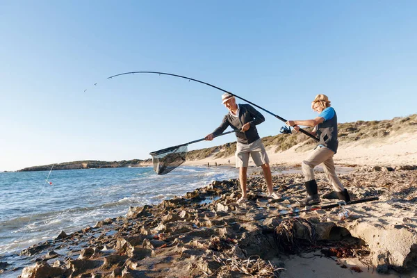 Hombre mayor pescando con su nieto —  Fotos de Stock