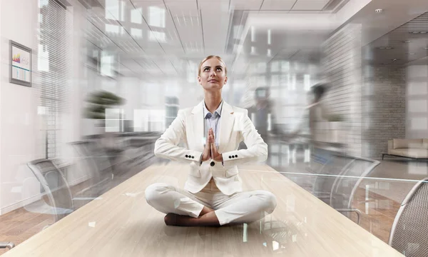 Business lady meditating at work. Mixed media — Stock Photo, Image