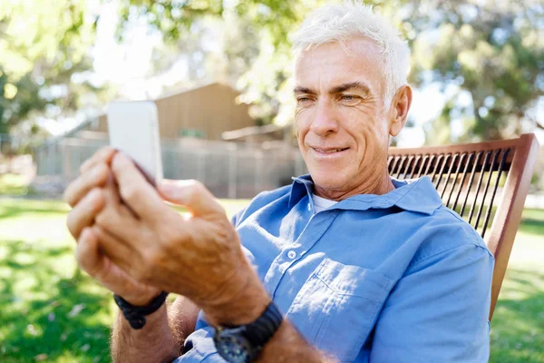 Lomature man buitenshuis gebruik mobiele telefoon — Stockfoto