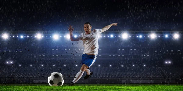 Soccer player at stadium. Mixed media — Stock Photo, Image