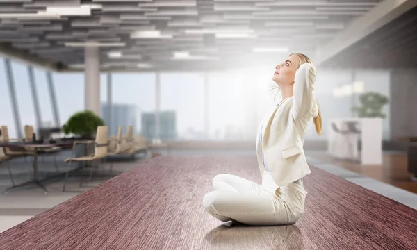 Business lady meditating at work. Mixed media — Stock Photo, Image