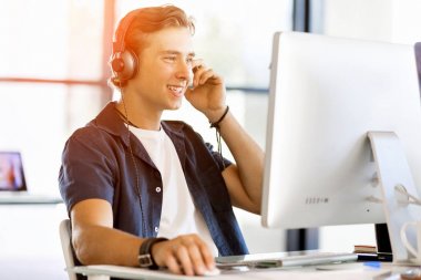 Kulaklıklar ile ofiste genç adam