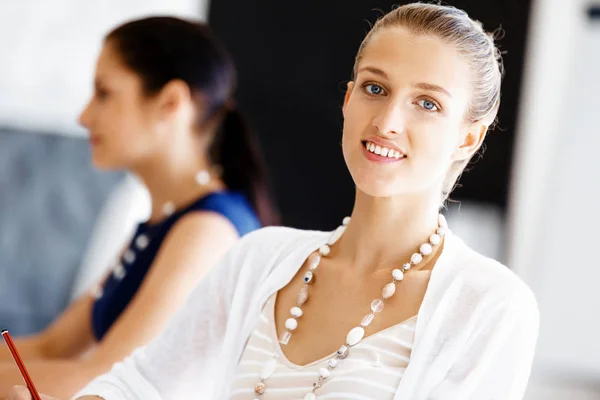 Attractive office worker sitting at desk — Stock Photo, Image