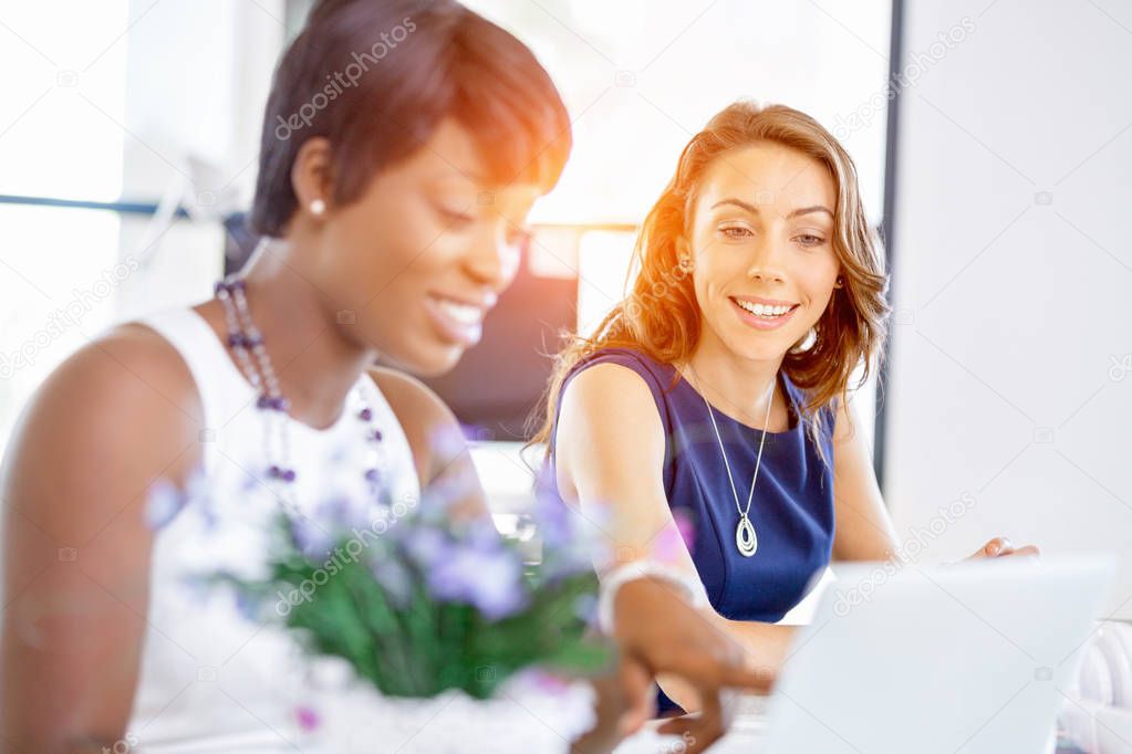 Women working together, office interior