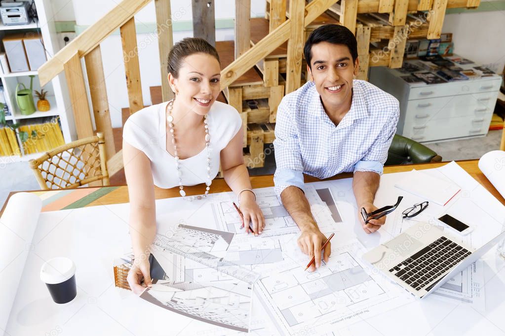 Two young architects in office