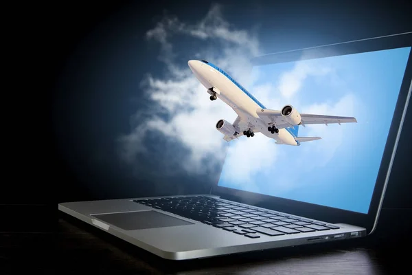 Airliner coming from laptop. Mixed media — Stock Photo, Image
