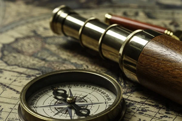 Retro compass with old map and spyglass Stock Picture