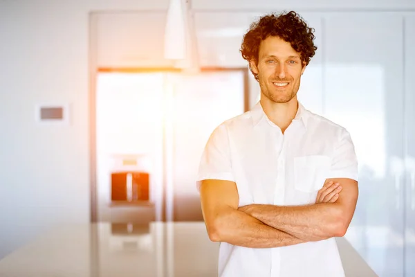Muotokuva fiksu nuori mies seisoo keittiössä — kuvapankkivalokuva