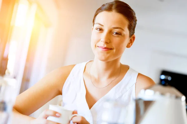 Mujer joven feliz con taza de té o café en casa —  Fotos de Stock