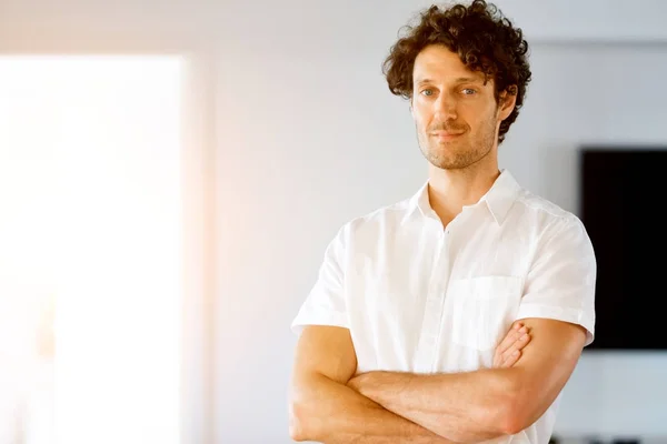 Portrait of a smart young man standing in kitchen — Stock Photo, Image