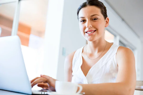 Jovem mulher bonita trabalhando em seu laptop — Fotografia de Stock