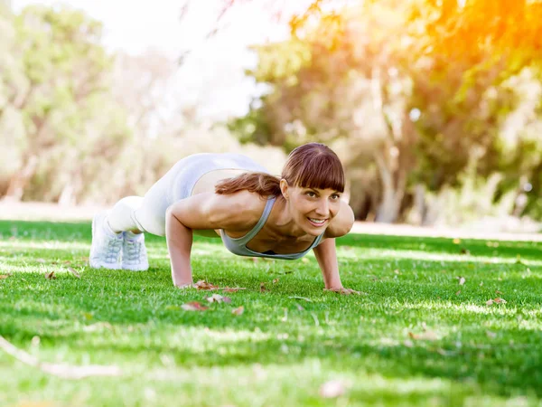 Mujer joven haciendo ejercicio en el parque —  Fotos de Stock