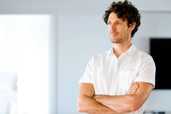 Portrait d'un jeune homme intelligent debout dans la cuisine — Photo