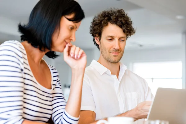 Happy modern couple working on laptop at home — Stock Photo, Image