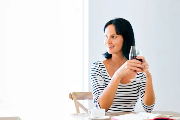 Beautiful young woman holding glass with red wine — Stock Photo, Image