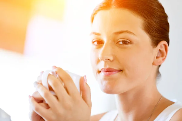 Mujer joven feliz con taza de té o café en casa — Foto de Stock