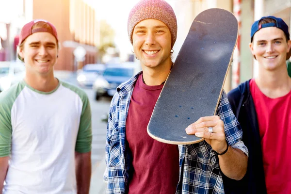 Amis adolescents marchant dans la rue avec des planches à roulettes — Photo