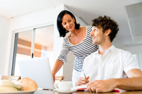 Happy modern couple working on laptop at home — Stock Photo, Image