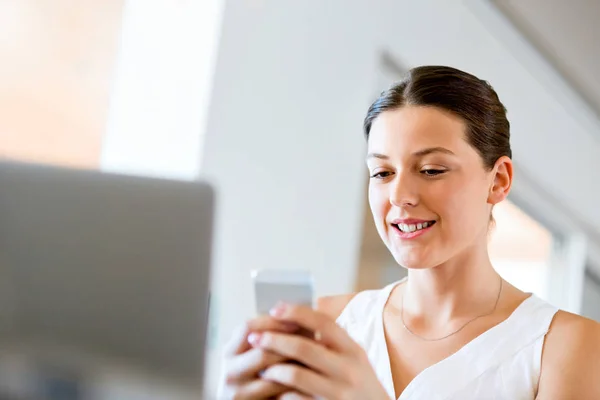 Portrait of young woman holding phone — Stock Photo, Image