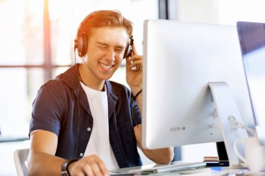 Kulaklıklar ile ofiste genç adam