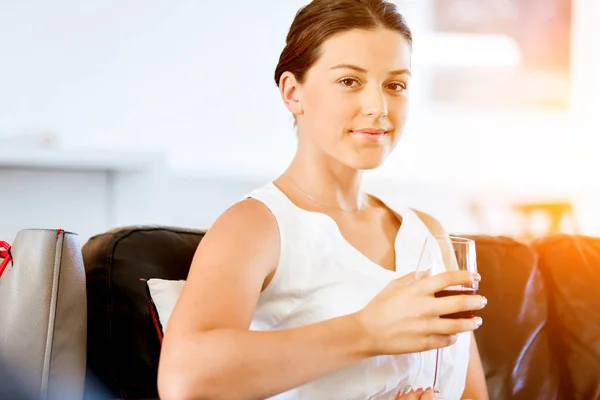 Beautiful young woman holding glass with red wine — Stock Photo, Image