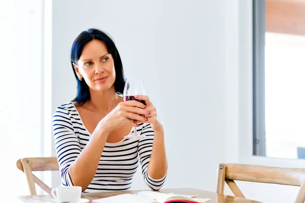 Beautiful young woman holding glass with red wine — Stock Photo, Image