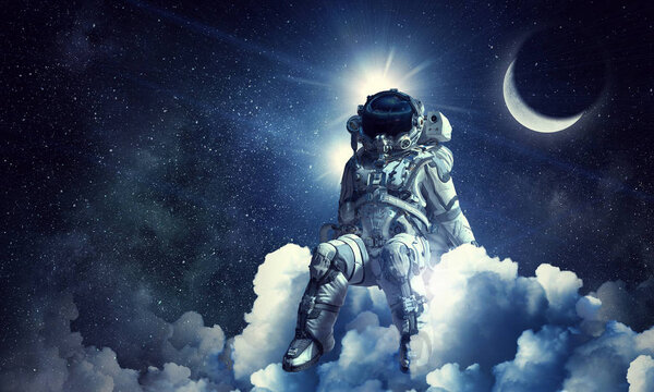 Spaceman sitting on cloud against dark starry sky. Mixed media