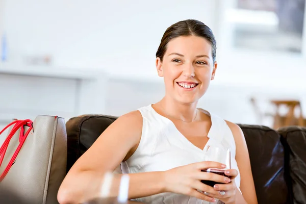 Beautiful young woman holding glass with red wine — Stock Photo, Image