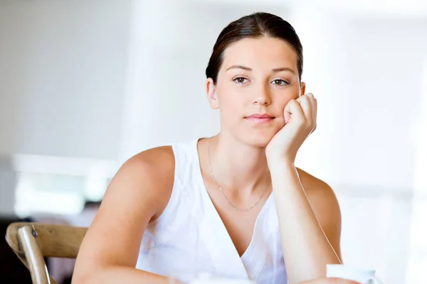 Happy young woman with cup of tea or coffee at home — Stock Photo, Image