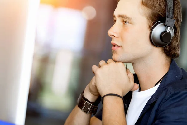 Young man in the office with headphones — Stock Photo, Image