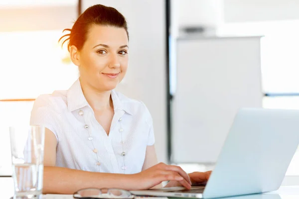 Portrait of businesswoman working at computer in office Stock Picture