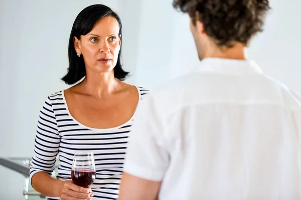 Vrouw met een glas wijn praten met een man — Stockfoto