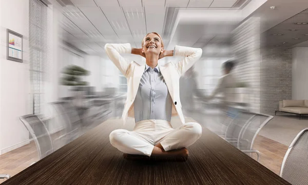 Business lady meditating at work. Mixed media — Stock Photo, Image