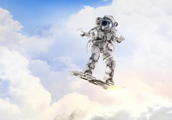 Spaceman on flying board. Mixed media — Stock Photo, Image